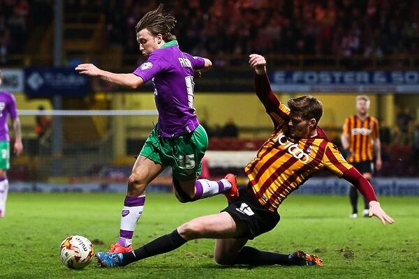 Intense Battle: Ben Williams Tackles Luke Freeman in Bradford City vs. Bristol City Football Match