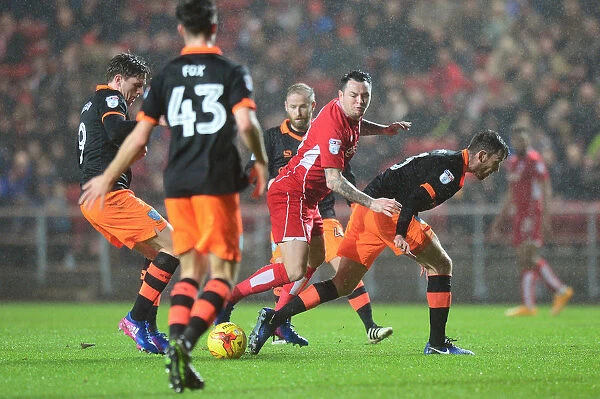 Intense Championship Clash: Lee Tomlin Tackled by Sheffield Wednesday Player