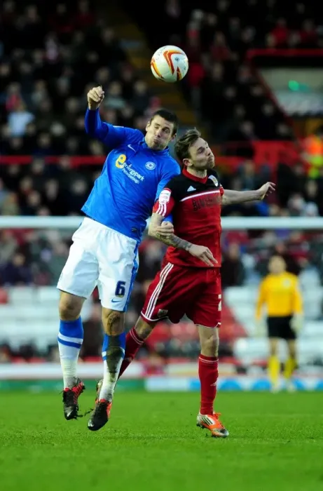 Framed Print : Intense Header Battle: Paul Anderson vs Michael Bostwick - Bristol City vs Peterborough United