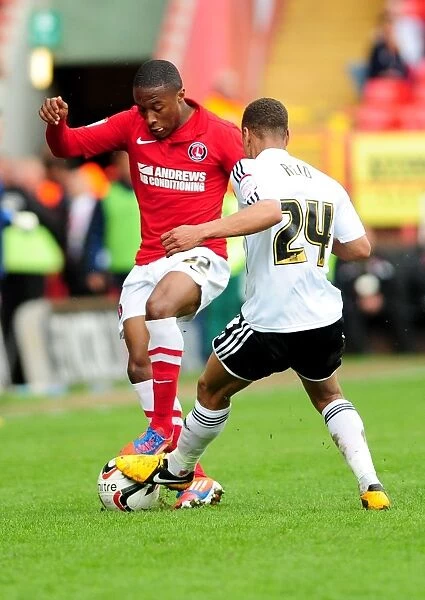 Intense Moment: Bobby Reid vs. Callum Harriott - A Hard-Fought Tackle in the Npower Championship Clash Between Charlton Athletic and Bristol City
