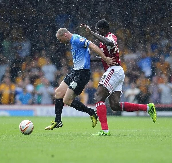 Intense Moment: Jay Emmanuel-Thomas Chases Down Gary Jones during Bristol City vs Bradford City Football Match