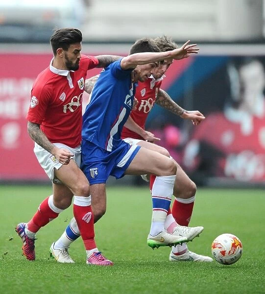 Intense Rivalry: Aden Flint and Marlon Pack of Bristol City Clash with John Marquis of Gillingham