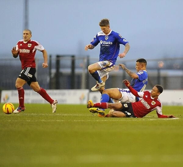 Intense Rivalry: Bobby Reid vs Korey Smith - A Hard-Fought Tackle in the Oldham Athletic vs Bristol City Football Rivalry, Football League One, 2014