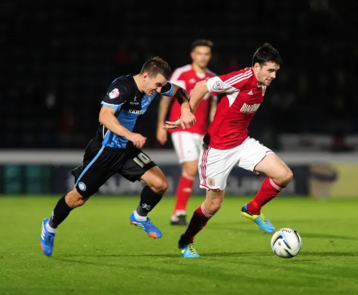 Framed Print : Intense Rivalry: Bristol City vs Wycombe Wanderers in the Johnstone's Paint Trophy Clash at Adams Park (October 8, 2013)