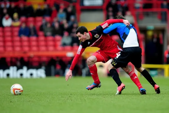 Framed Print : Intense Rivalry: Cunningham vs. O'Brien's Battle for Ball Possession, Bristol City vs. Barnsley