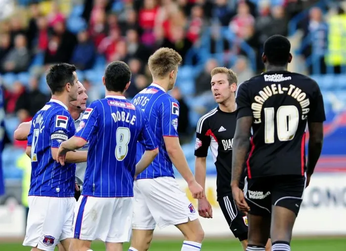 Framed Print : Intense Rivalry: Wagstaff vs. Potts Clash at Brunton Park - Football's Heated Moment between Scott Wagstaff and Brad Potts