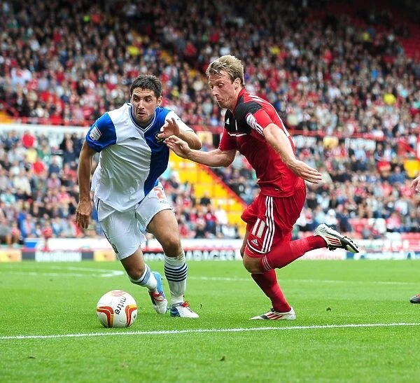 Intense Rivalry: Woolford vs. Orr - A Battle for the Ball in the Bristol City vs. Blackburn Rovers Championship Clash