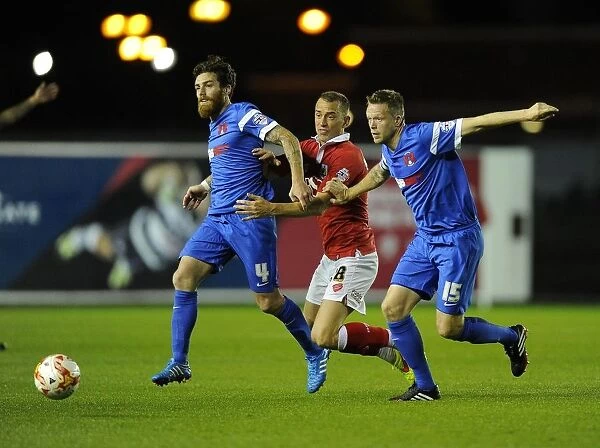 Intense Triangle Tussle: Baldock, Vincelot, and Clarke Fight for Possession in Bristol City vs Leyton Orient (Football)