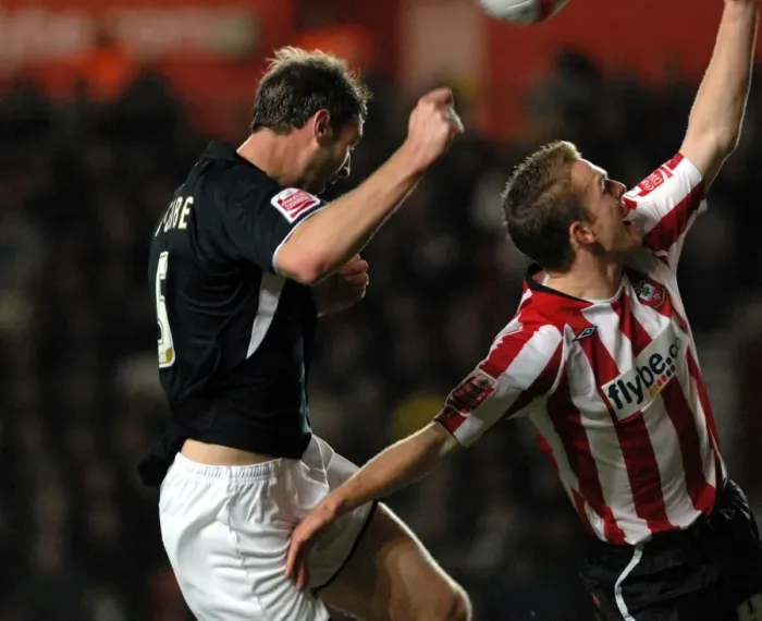 Framed Print : Jamie McCombe header is blocked by the hand of saints defender alex pearce Framed Print : Jamie McCombe header is blocked by the hand of saints defender alex pearce