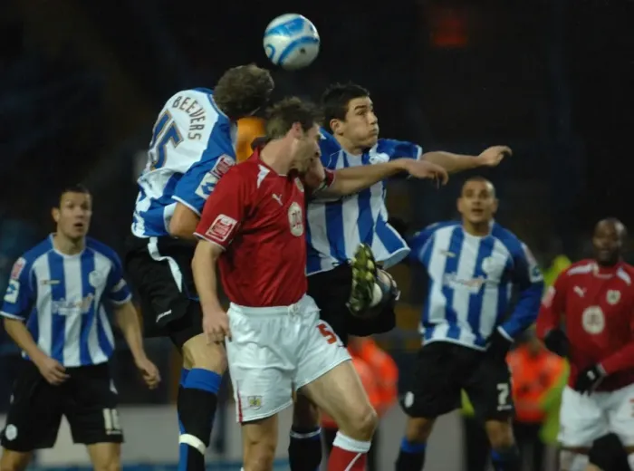 Framed Print : Jamie McCombe jumps to compete with the sheffield wednesday defence Framed Print : Jamie McCombe jumps to compete with the sheffield wednesday defence