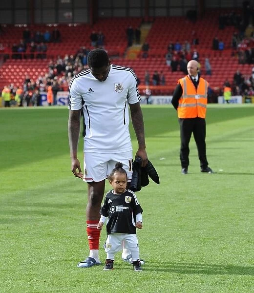 Jay Emmanuel-Thomas of Bristol City Celebrates with His Child after Securing Promotion to League One