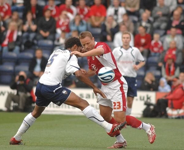 Lee Trundle and Youl Mawene tussle for the