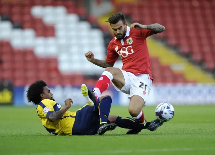 Framed Print : Marlon Pack vs. Junior Brown: Intense Battle for the Ball in Bristol City vs. Oxford United