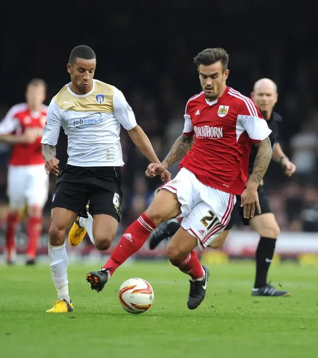 Framed Print : Maron Pack vs Craig Eastmond: Intense Battle for Possession in Bristol City vs Colchester United Football Match, September 2013