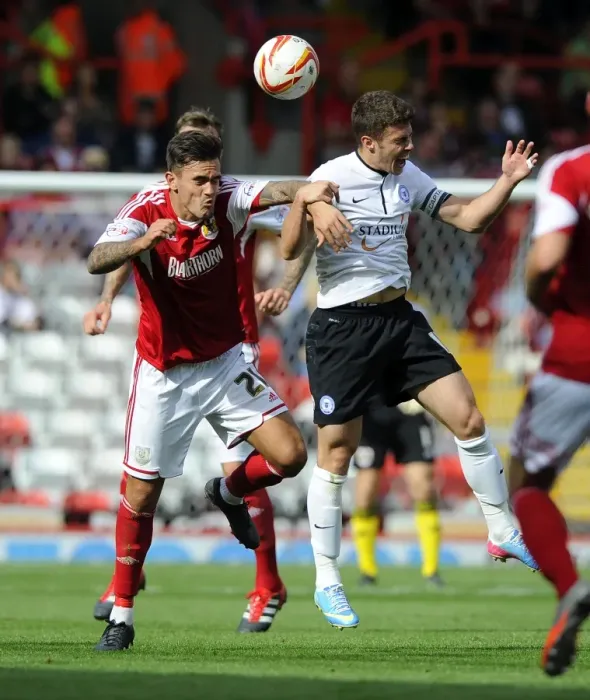 Framed Print : Maron Pack vs. Tommy Rowe: Aerial Clash in Bristol City vs. Peterborough United Framed Print : Maron Pack vs. Tommy Rowe: Aerial Clash in Bristol City vs. Peterborough United