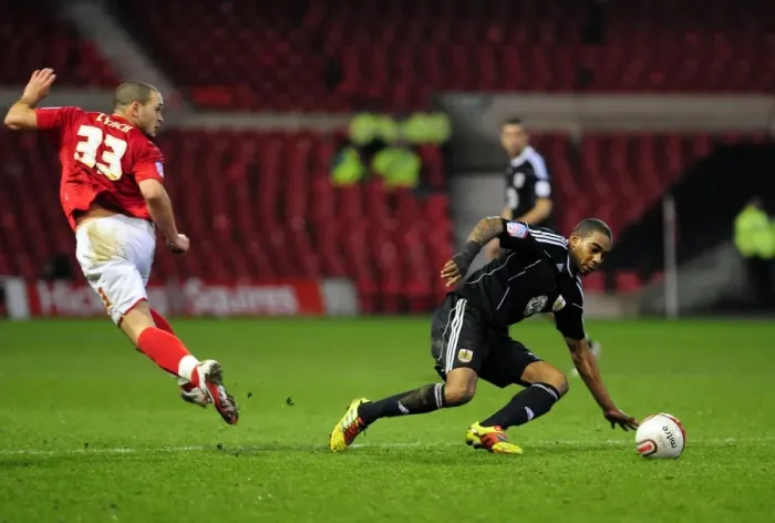 Framed Print : Marvin Elliott Tackles Joel Lynch in Intense Forest vs. Bristol City Championship Clash