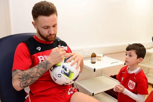 Matty Taylor Greets Mascot with Autographs Before Bristol City vs. Fulham