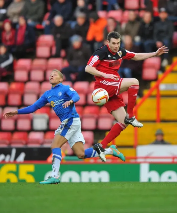 Framed Print : McManus vs Gayle: Aerial Battle in Championship Football - Bristol City vs Peterborough United