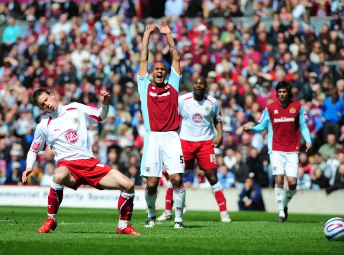Framed Print : Michael McIndoe shoots whilst Clarke Carlisle appeals for offside Framed Print : Michael McIndoe shoots whilst Clarke Carlisle appeals for offside