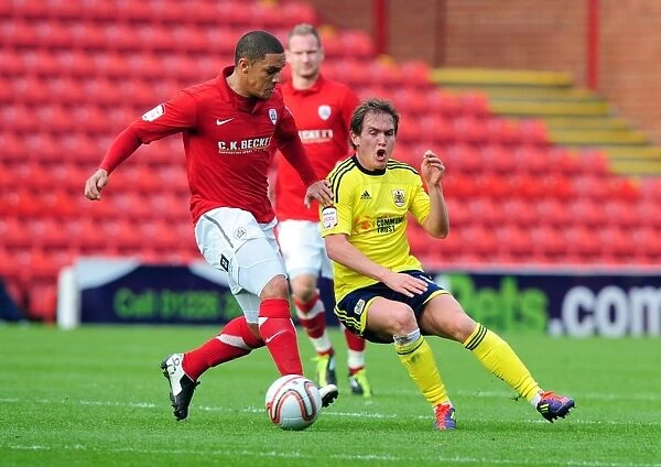 Neil Kilkenny vs. Nathan Doyle: Intense Battle for the Ball in the 2011 Championship Match between Barnsley and Bristol City