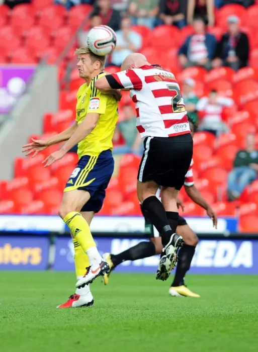 Framed Print : Nicky Maynard Flicks Ahead of James O'Connor in Doncaster Rovers vs. Bristol City League Cup Clash - 27 / 08 / 2011