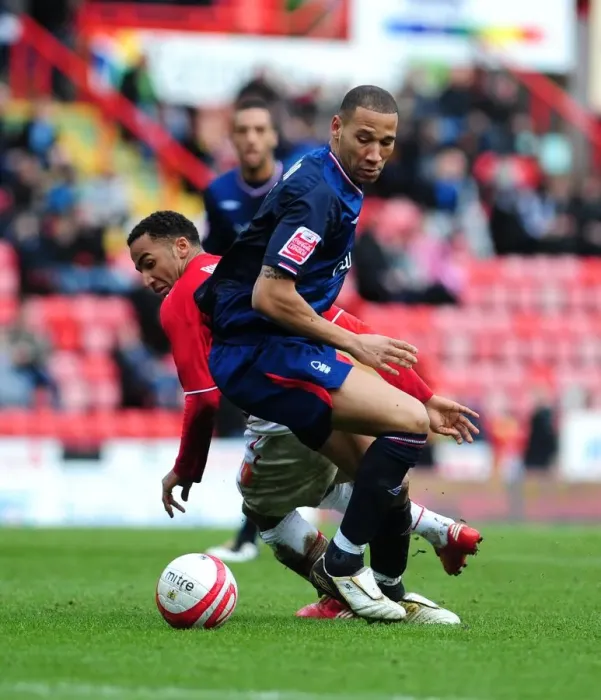 Framed Print : Nicky Maynard Slips Past Kelvin Wilson: A Pivotal Moment in the 2010 Championship Clash Between Bristol City and Nottingham Forest