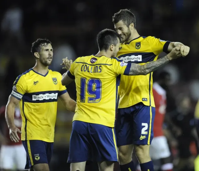 Framed Print : Oxford United's Upset Victory: Jonathan Meades and Michael Collins Celebrate Overpowering Bristol City