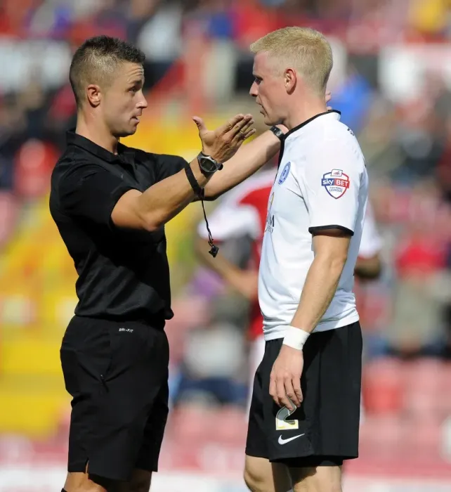 Framed Print : Referee James Adcock Confers with Craig Alcock of Peterborough United during Bristol City vs Peterborough United, Sky Bet League One (Football Match)