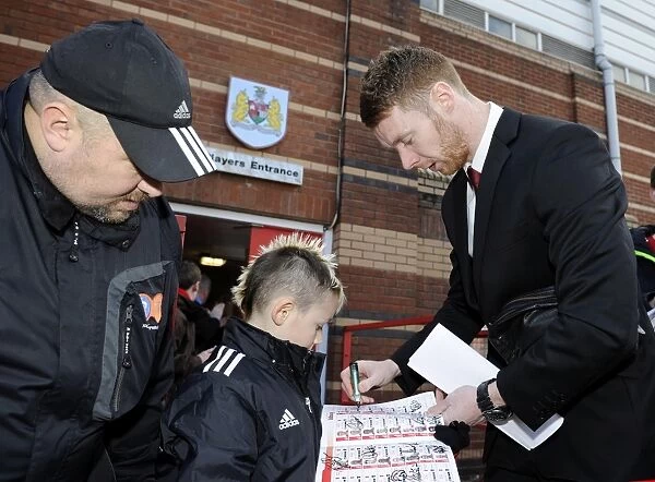 Stephen Pearson of Bristol City Greets Young Fan with Autograph at Ashton Gate