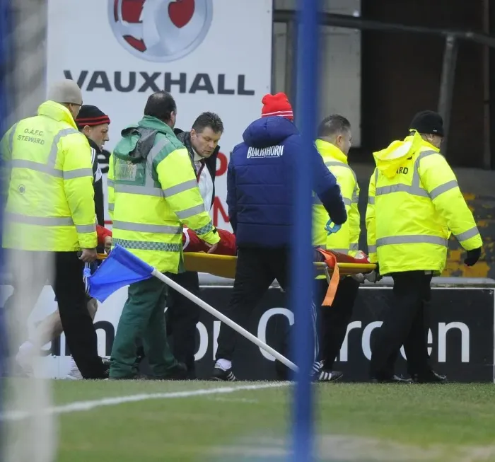 Framed Print : Steve Cotterill Comforts Injured Marvin Elliott: Oldham Athletic vs. Bristol City, 08-02-2014