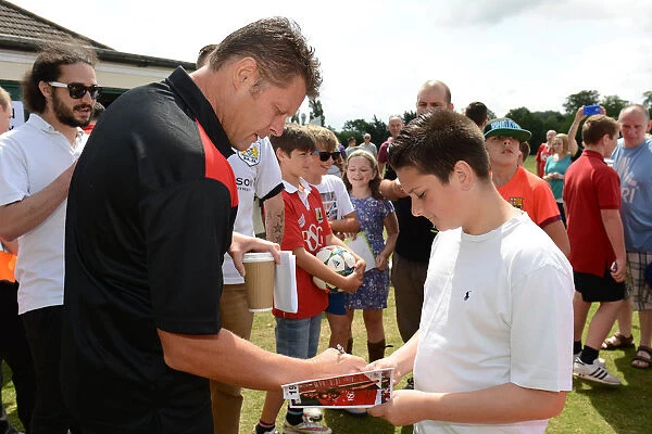 Steve Cotterill Signs Autograph for Fan at Bristol City's Community Match vs. Brislington and Keynsham Town