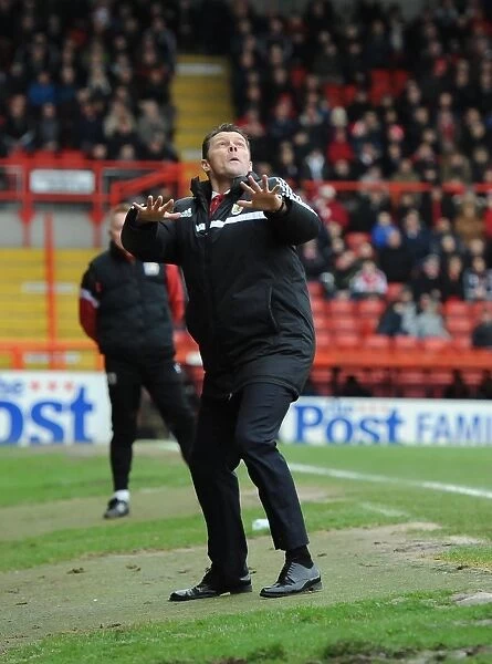 Steve Cotterill's Playful Moment: A Distracted Focus at Ashton Gate during Bristol City vs MK Dons (18 / 01 / 2014)