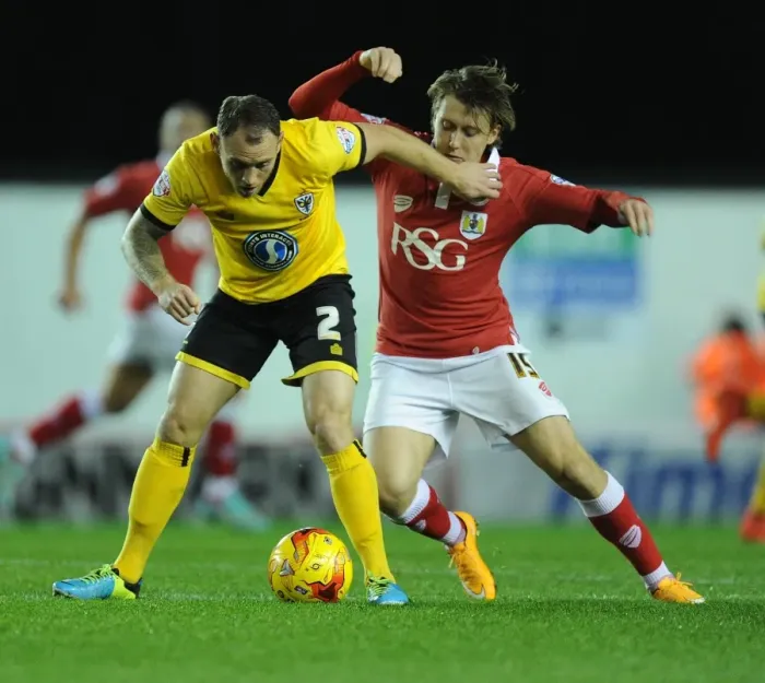 Framed Print : Tense Moment: Osborne Holds Back Fuller in Bristol City vs AFC Wimbledon Match Framed Print : Tense Moment: Osborne Holds Back Fuller in Bristol City vs AFC Wimbledon Match