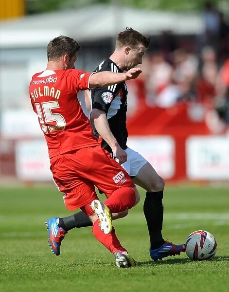Wade Elliott Holds Firmly Against Crawley Town Pressure: A Moment from the Crawley Town vs. Bristol City Football Match, May 3, 2014