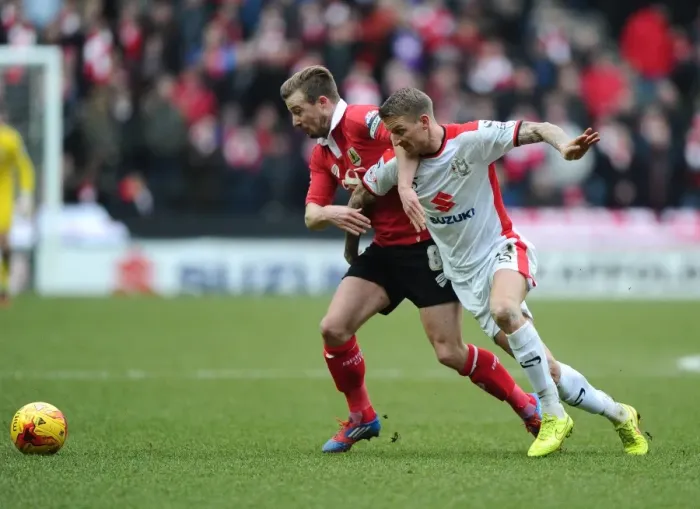 Framed Print : Wade Elliott vs. Carl Baker: Intense Battle for Ball Possession in MK Dons vs. Bristol City Football Match, February 2015