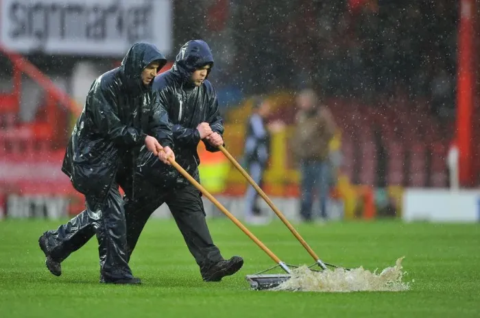 Framed Print : Winter's Battle: Referee Stops Bristol City vs. Watford Amidst Grounds Crew's Persistent Clearing Efforts