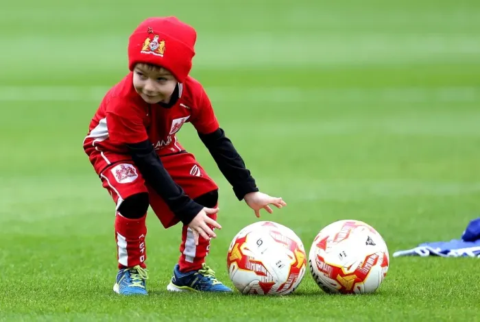 Framed Print : Young Bristol City Fan Helps Players with Footballs during Barnsley vs. Bristol City Match at Oakwell Stadium (2016)