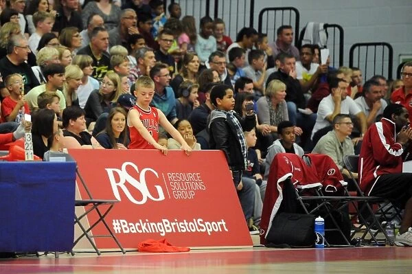 Young Fan Holds RSG Board at Bristol Flyers vs. Plymouth Raiders Basketball Game