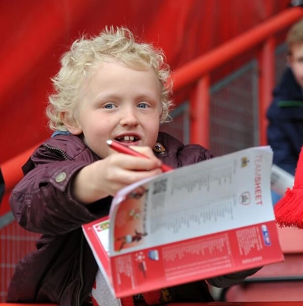 Young Fan Seeks Player Autographs at Ashton Gate Stadium before Bristol City vs Barnsley Match