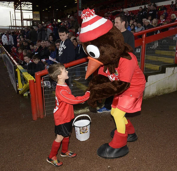 Young Fan Shares a Moment with Scrumpy, the Bristol City Mascot