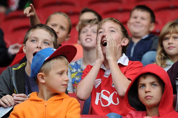 Young Fan's Hopeful Gaze at Bristol City vs MK Dons Match, 2015