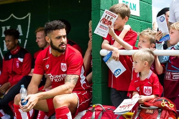 Young Fans Seek Autograph from Derrick Williams at Hengrove Athletic vs. Bristol City Match