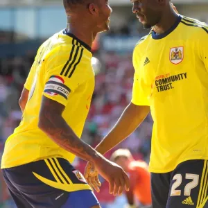 Bristol City's Albert Adomah and Marvin Elliott celebrate a goal in print