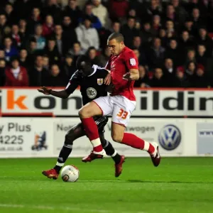Adomah vs. Lynch: Intense Battle for Ball Possession during Forest vs. Bristol City Championship Clash, January 2011