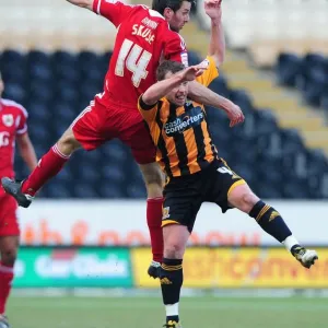 Print of a football player in mid-air, battling for the ball