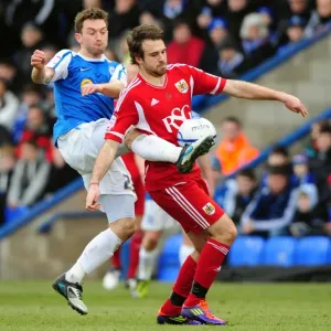 Battling for Supremacy: Brett Pitman vs. Lee Frecklington in Peterborough United vs. Bristol City Football Match