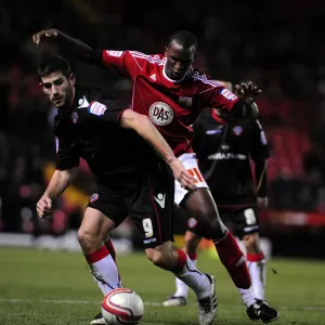 Battling for Supremacy: Cisse vs. Evans in the Championship Clash between Bristol City and Sheffield United (November 2010)
