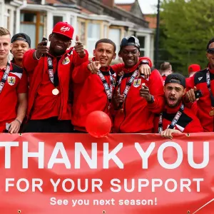 Bristol City Champions: Bryan, Reid, Emmanuel-Thomas, Tavernier, Kieran Agard, Derrick Williams, and Korey Smith Celebrate Promotion to Championship on Bus Parade Bristol City Champions: Bryan, Reid, Emmanuel-Thomas, Tavernier, Kieran Agard, Derrick Williams, and Korey Smith Celebrate Promotion to Championship on Bus Parade