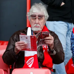 Bristol City Fan Absorbed in Match Program before FA Cup Clash vs. West Ham United Bristol City Fan Absorbed in Match Program before FA Cup Clash vs. West Ham United
