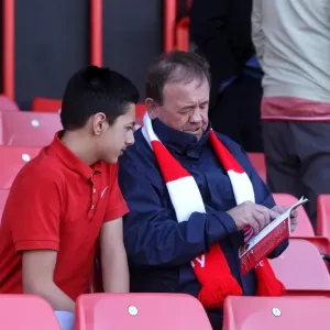 Bristol City Fans Engrossed in Match Day Programme Print Bristol City Fans Engrossed in Match Day Programme Print